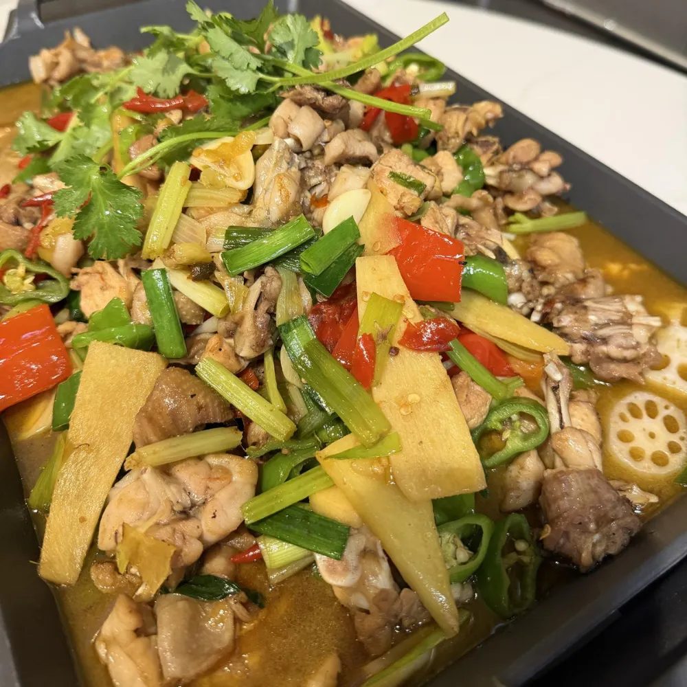 Braised bullfrog chunks with lotus root and mixed peppers at Xu's grill, a Chinese Restaurant in Flushing
