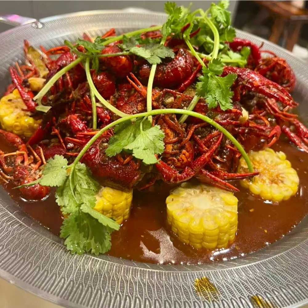 Spicy crayfish stewed with corn, garnished with coriander at Xu's grill, a Chinese Restaurant in Flushing
