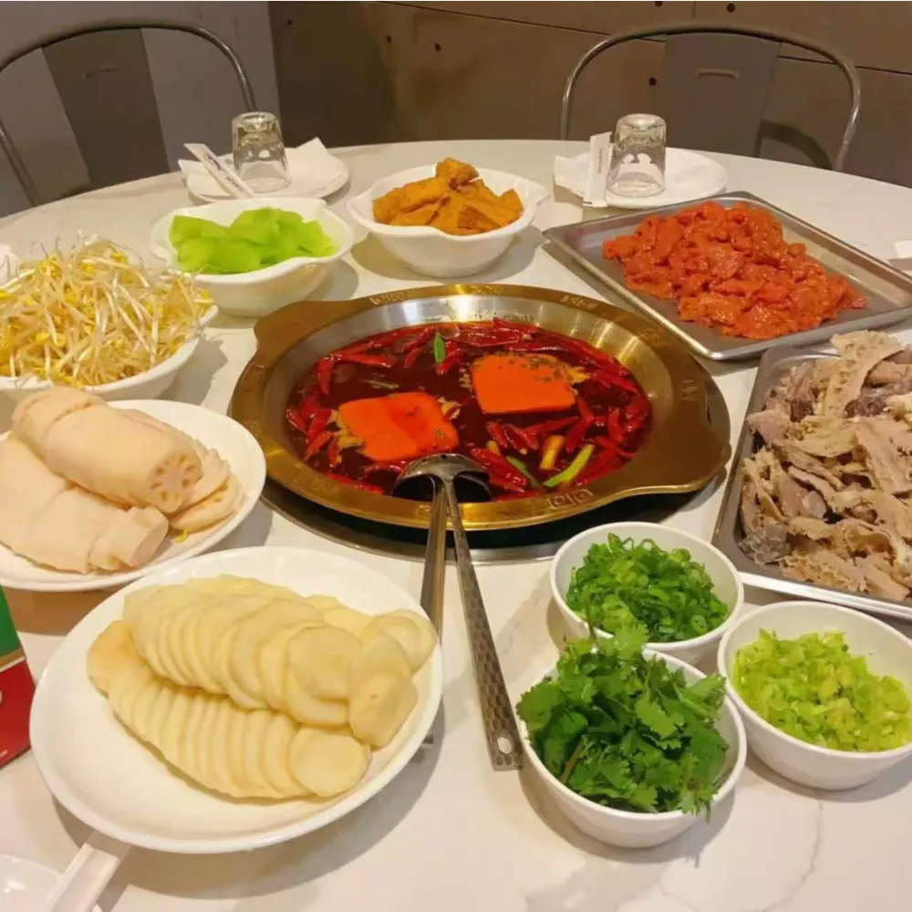 Spicy red oil hot pot with assorted fresh ingredients at Xu's grill, a Chinese Restaurant in Flushing