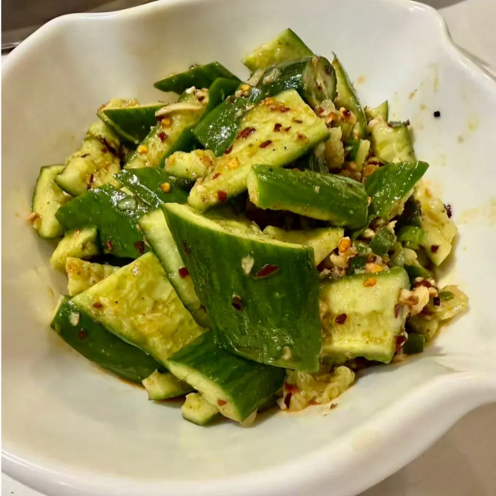 Spicy smashed cucumber salad with chili seasonings at Xu's grill, a Chinese Restaurant in Flushing